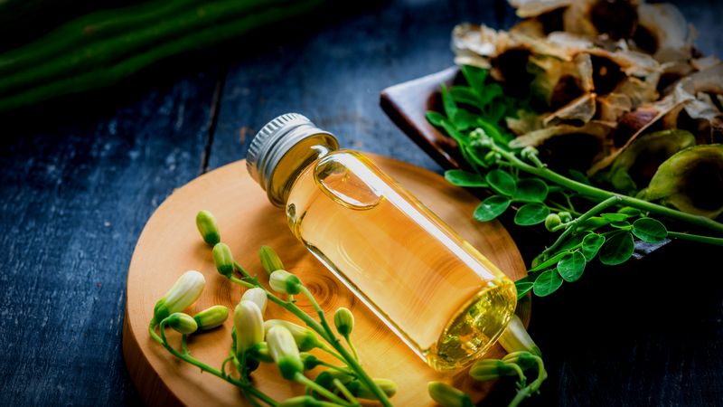 Moringa oil, leaves, and seed pods, Moringa oleifera.